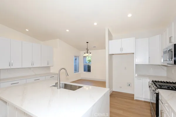 a view of a kitchen with a sink and a fireplace