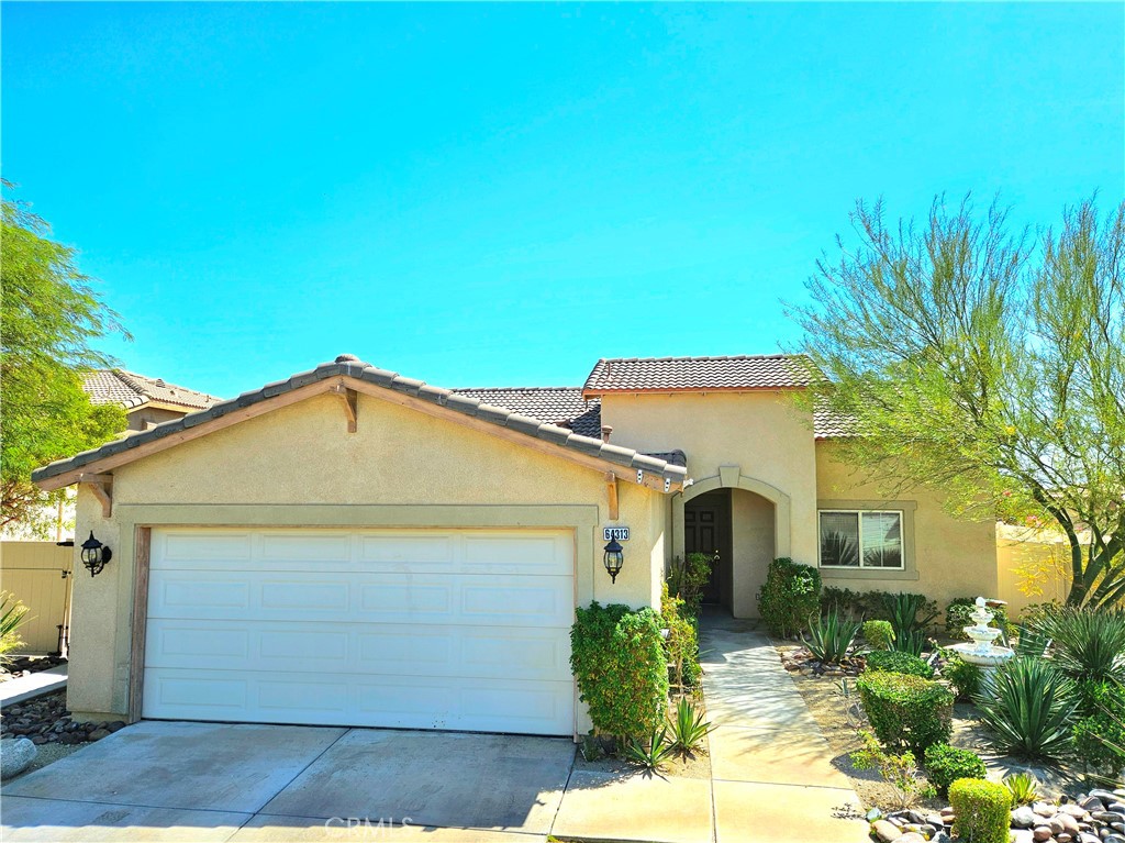 64313 Pyrenees Avenue Desert Hot Springs, CA 92240 - Photo 1 of 26 a front view of a house with a yard