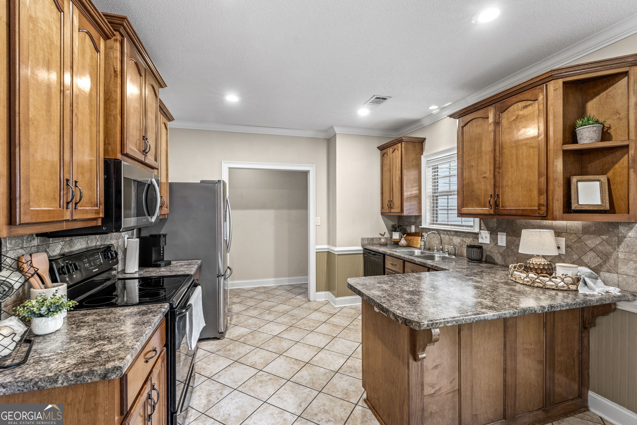 620 Amherst Street Kathleen, GA 31047 - Photo 12 of 31 a kitchen with stainless steel appliances granite countertop a sink stove and cabinets