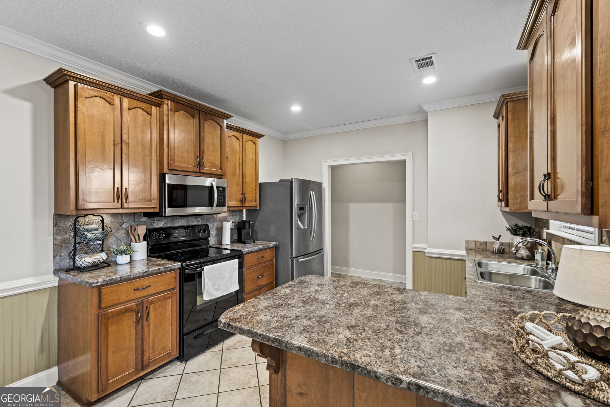 620 Amherst Street Kathleen, GA 31047 - Photo 13 of 31 a kitchen with stainless steel appliances granite countertop sink microwave and refrigerator