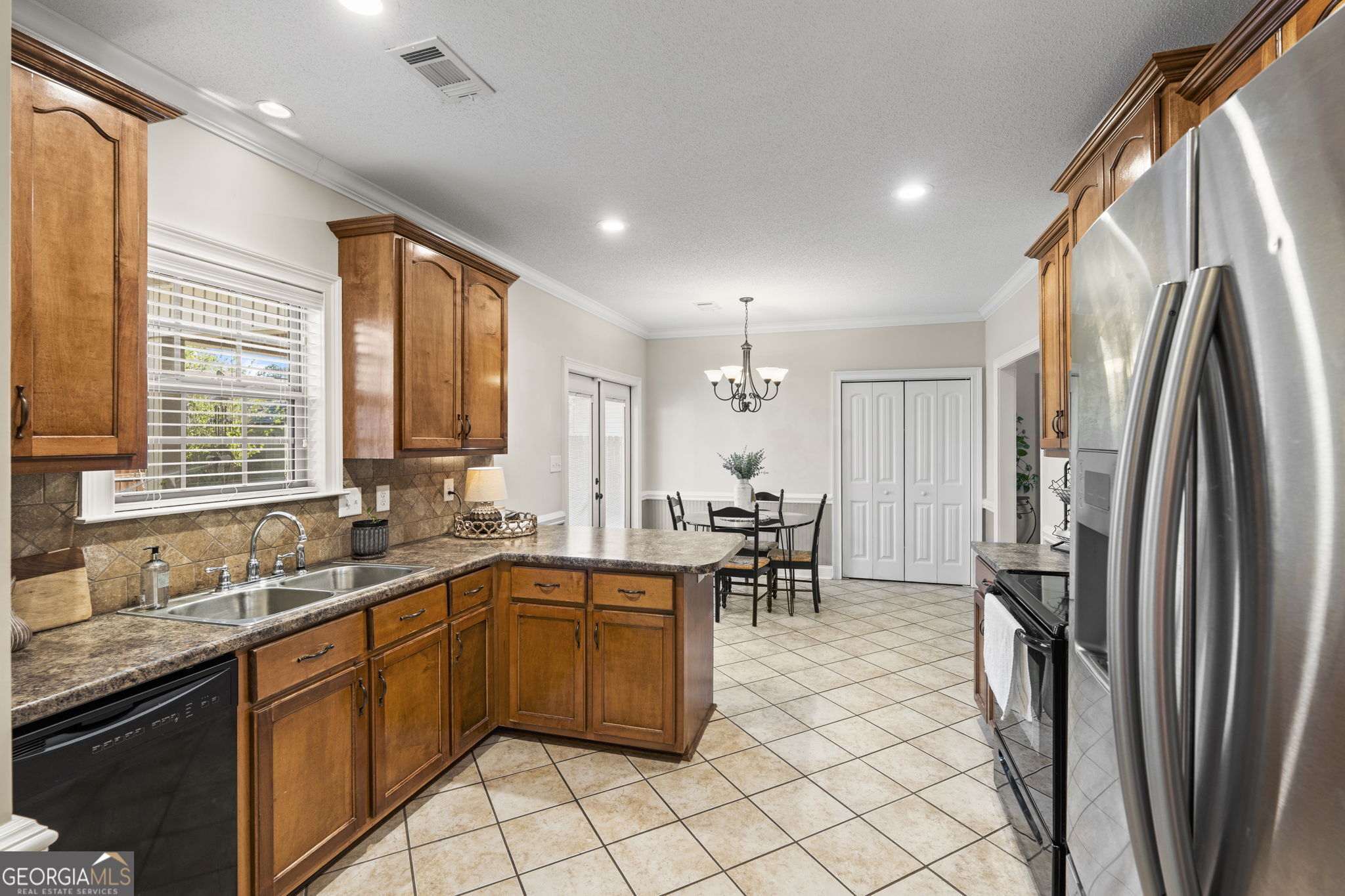 620 Amherst Street Kathleen, GA 31047 - Photo 14 of 31 a kitchen with sink cabinets and stainless steel appliances