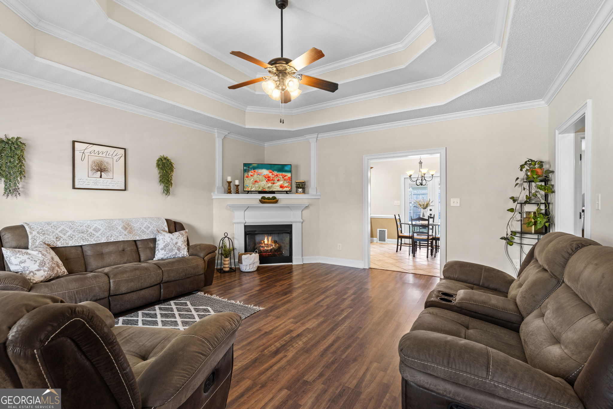 620 Amherst Street Kathleen, GA 31047 - Photo 6 of 31 a living room with furniture a fireplace and a chandelier