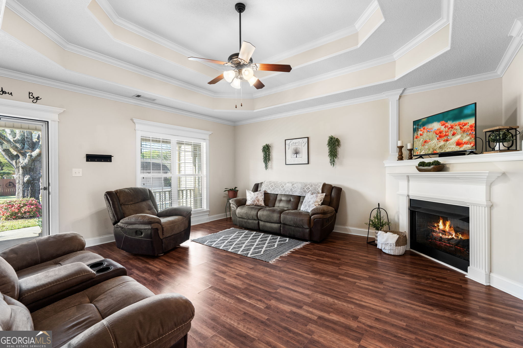 620 Amherst Street Kathleen, GA 31047 - Photo 8 of 31 a living room with furniture a fireplace and a flat screen tv