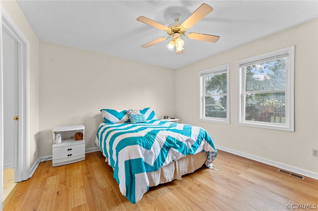 650 Johnson Road Mineral, VA 23117 - Photo 12 of 29 a bedroom with a bed and a chandelier