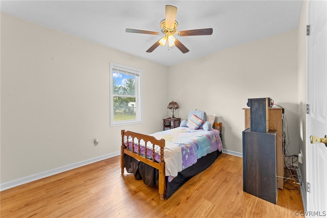 650 Johnson Road Mineral, VA 23117 - Photo 16 of 29 a bed room with a bed and a chandelier