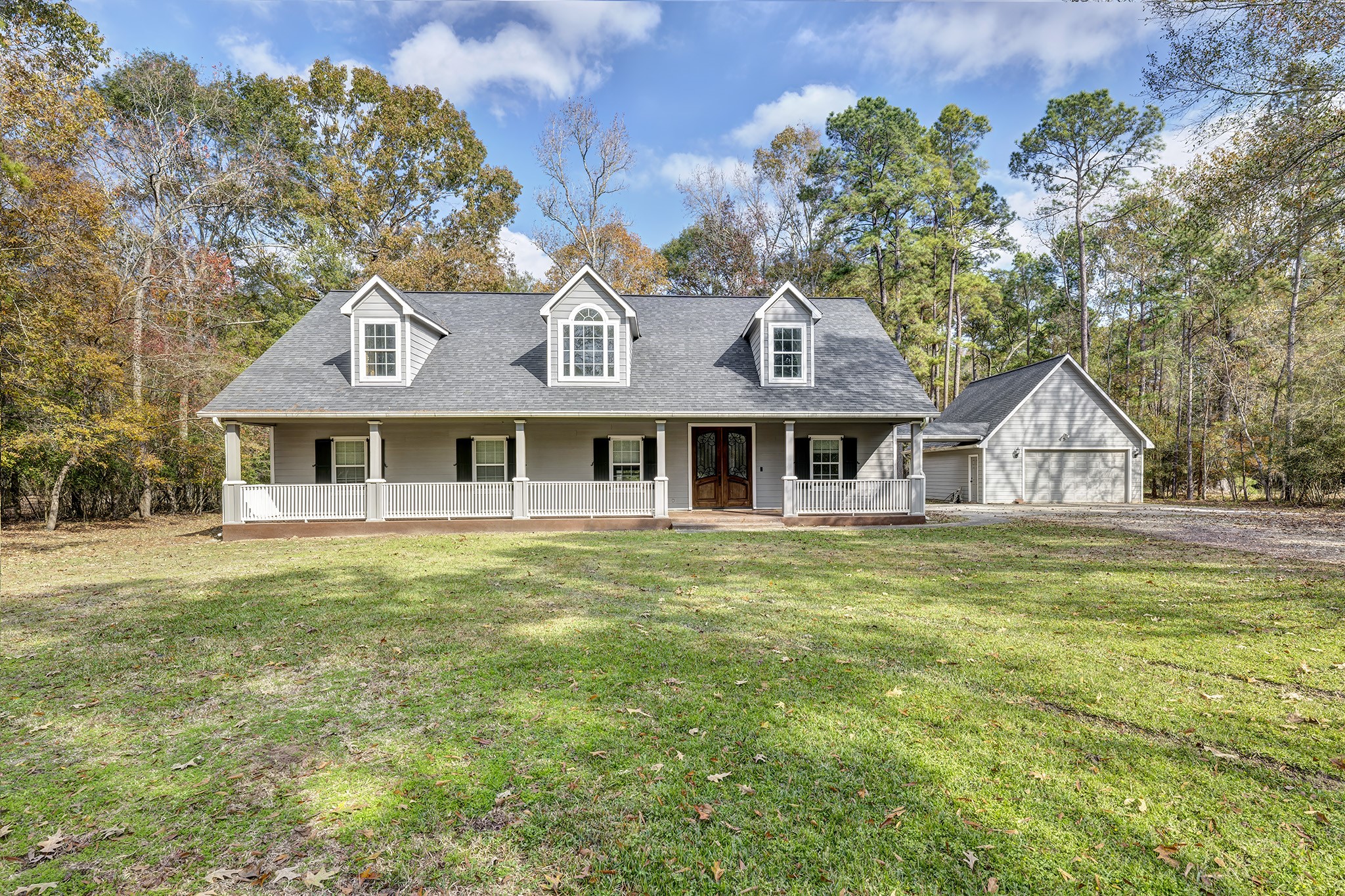 a front view of a house with a garden