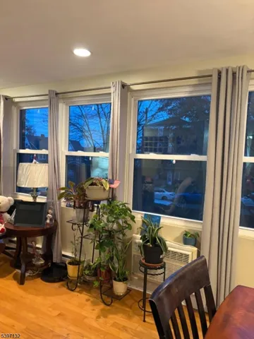 a room with lots of wooden furniture and a window