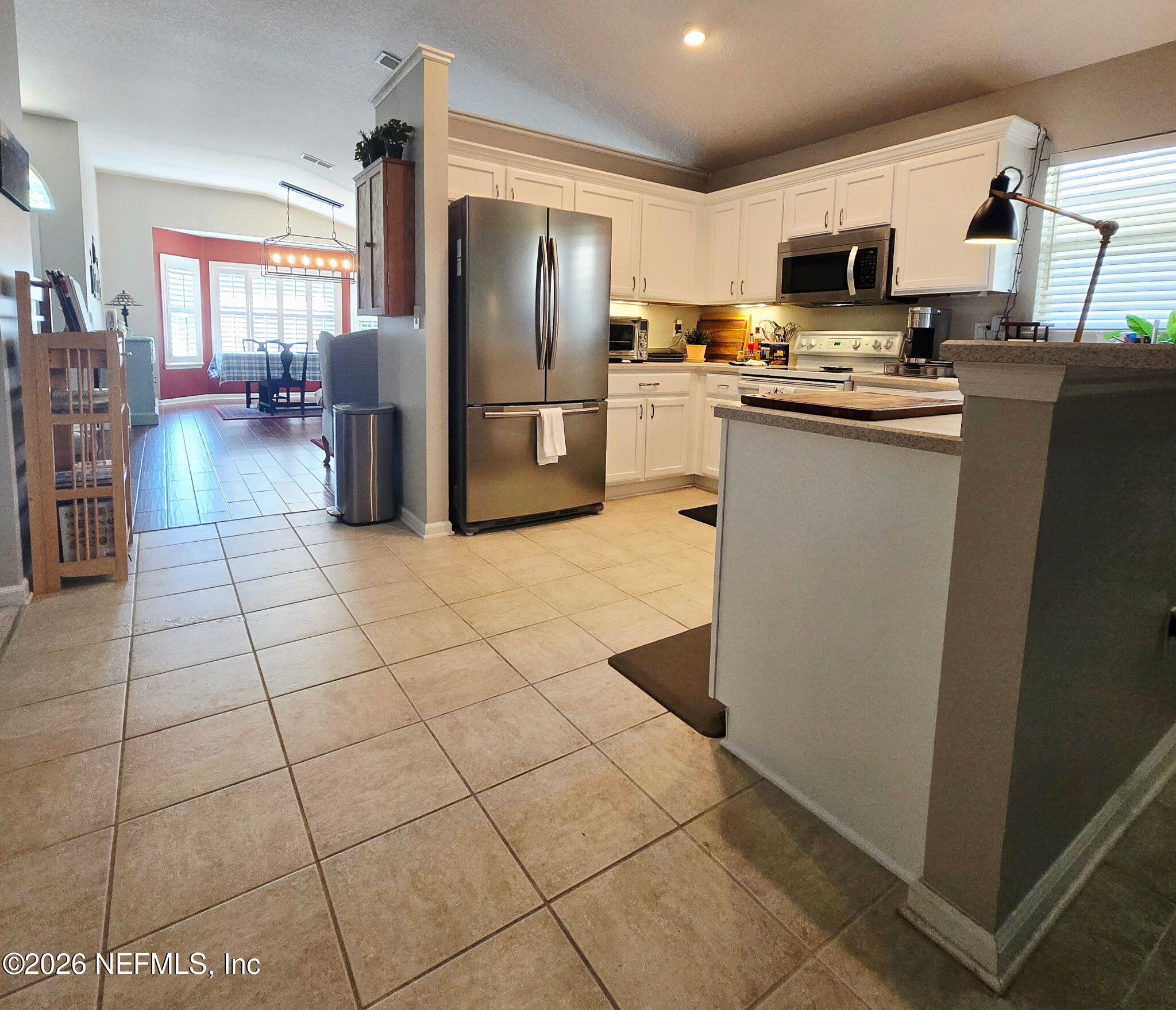 1424 Tintern Lane St. Augustine, FL 32092 - Photo 11 of 32 a kitchen with stainless steel appliances a refrigerator stove microwave and sink