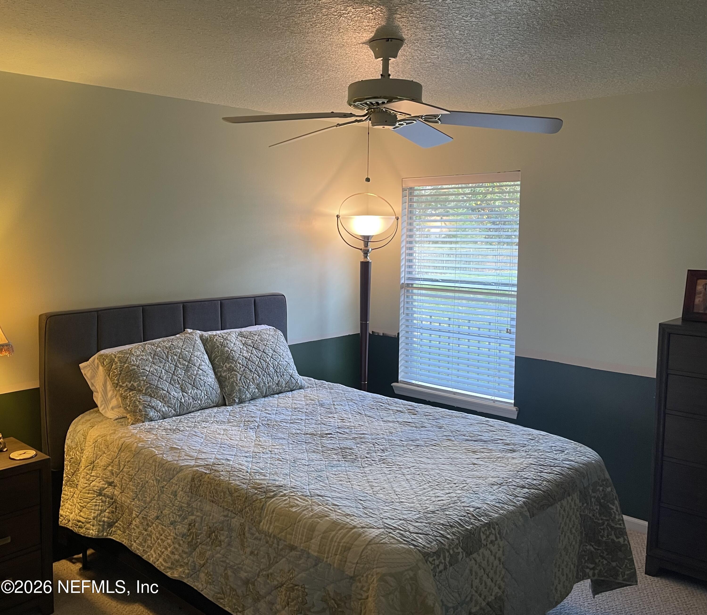 1424 Tintern Lane St. Augustine, FL 32092 - Photo 23 of 32 a bedroom with a bed and a chandelier