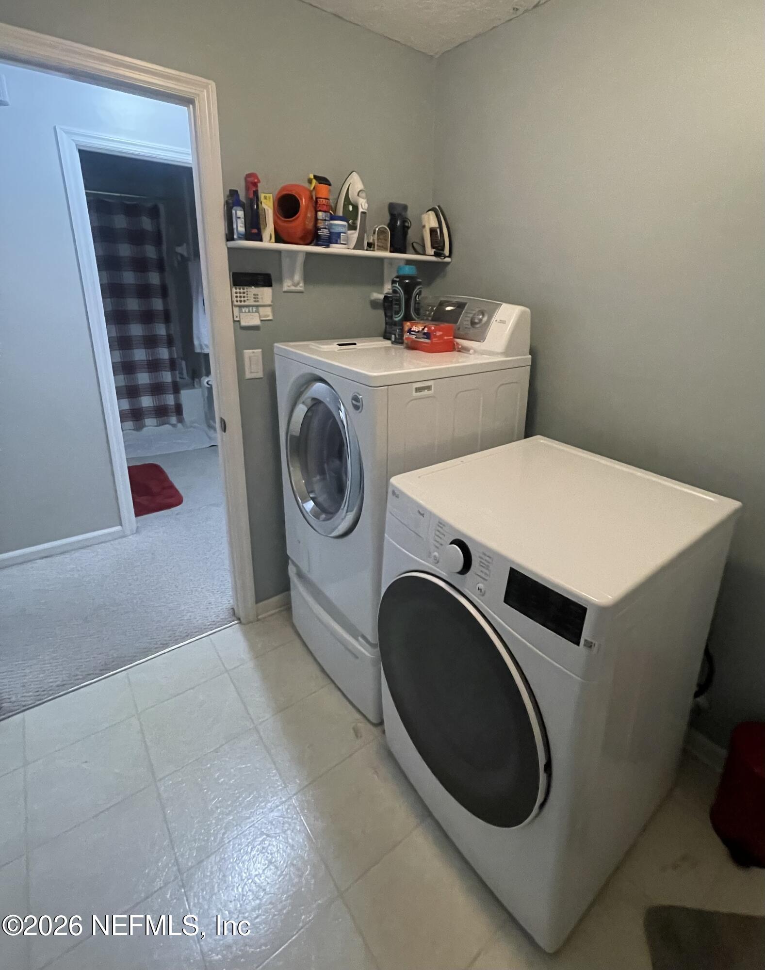 1424 Tintern Lane St. Augustine, FL 32092 - Photo 24 of 32 a utility room with dryer and washer