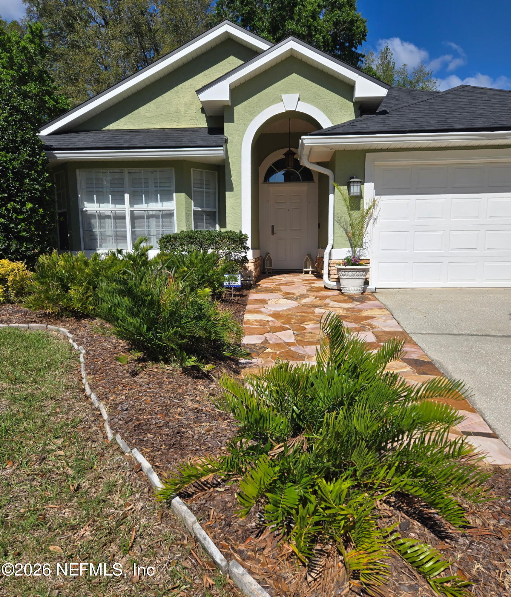 1424 Tintern Lane St. Augustine, FL 32092 - Photo 3 of 32 a front view of a house with garden