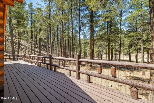 a view of a roof deck with wooden floor and fence