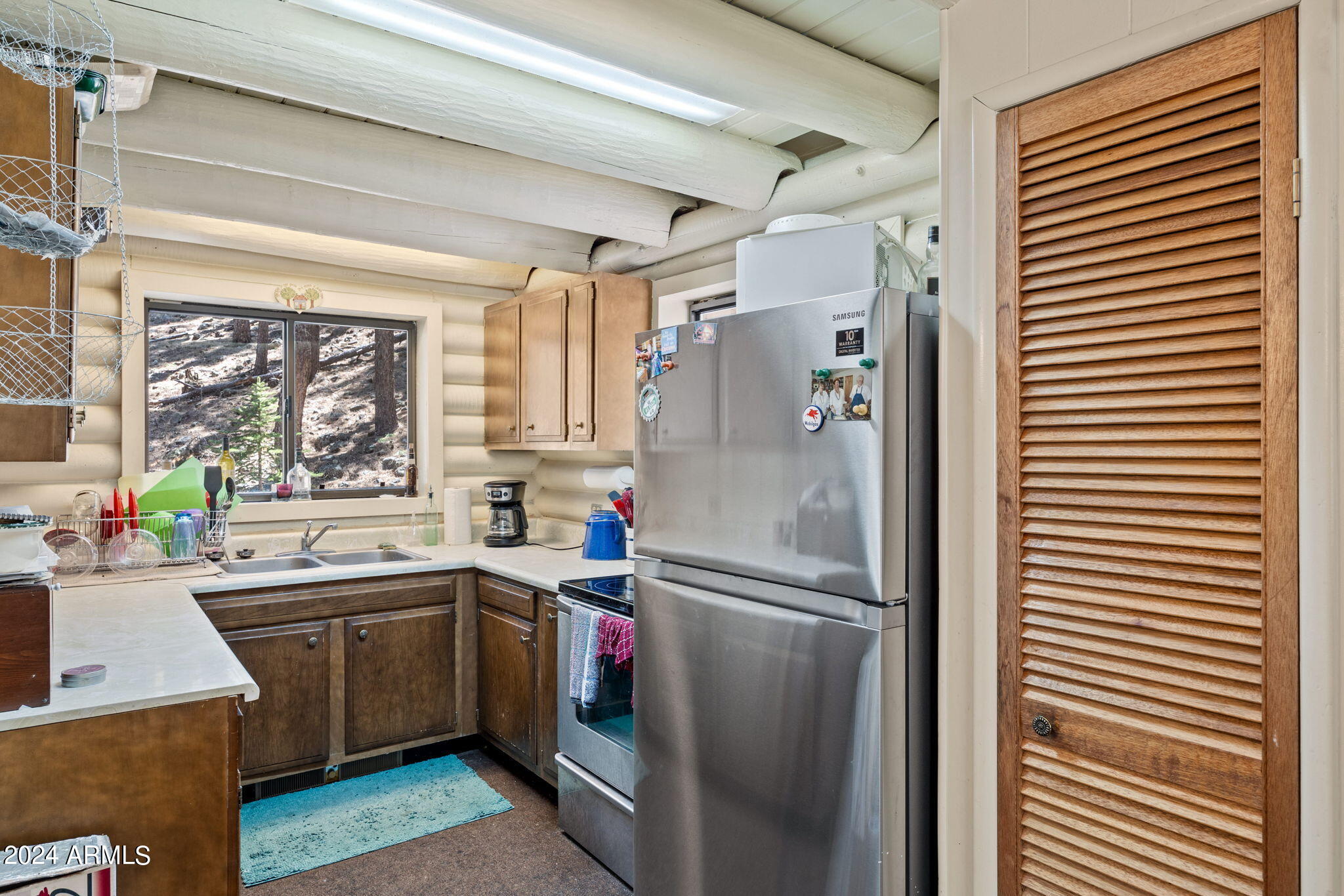 9 County Road Greer, AZ 85927 - Photo 26 of 33 a kitchen with stainless steel appliances a refrigerator sink and wooden floor