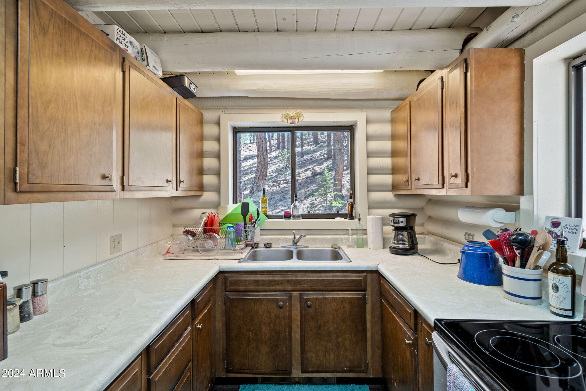 9 County Road Greer, AZ 85927 - Photo 27 of 33 a kitchen with stainless steel appliances a sink dishwasher and cabinets with wooden floor