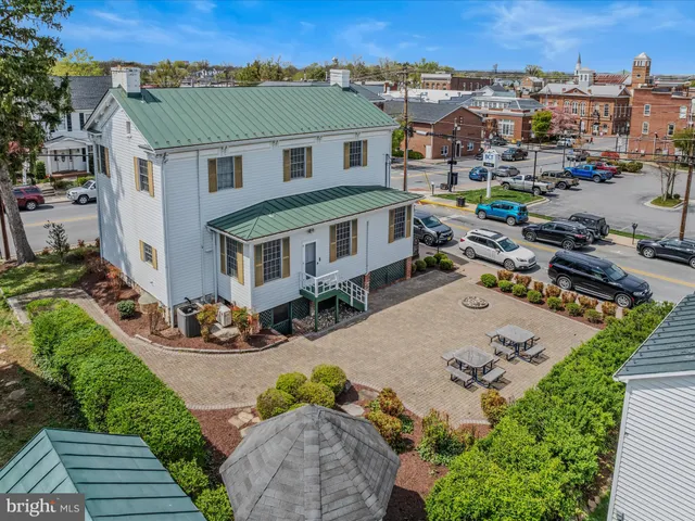 an aerial view of a house with a yard