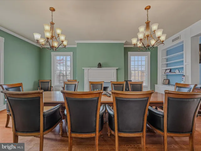a dining room with furniture a chandelier and a window