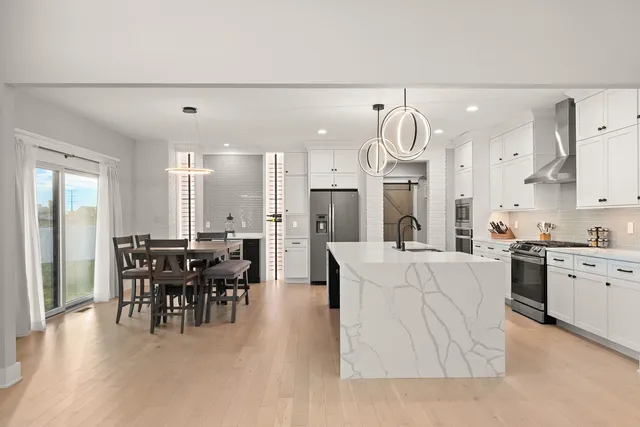 a large kitchen with cabinets table and chairs
