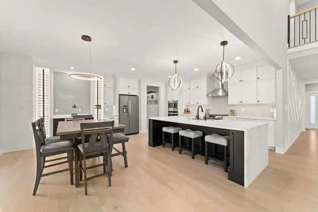 a large kitchen with a table and chairs