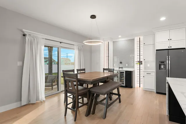a dining room with furniture and wooden floor