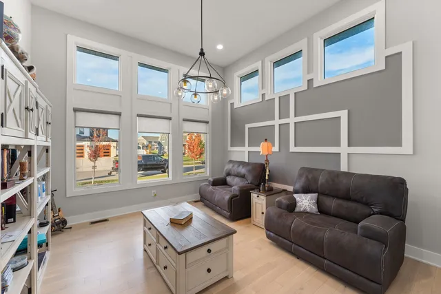 a living room with furniture a flat screen tv and a window