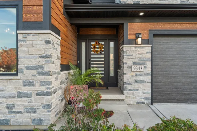 a front view of a house with potted plants