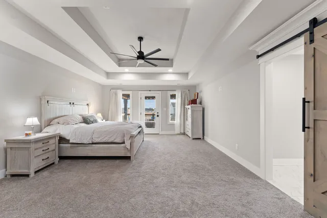 a bed room with a bed and a ceiling fan