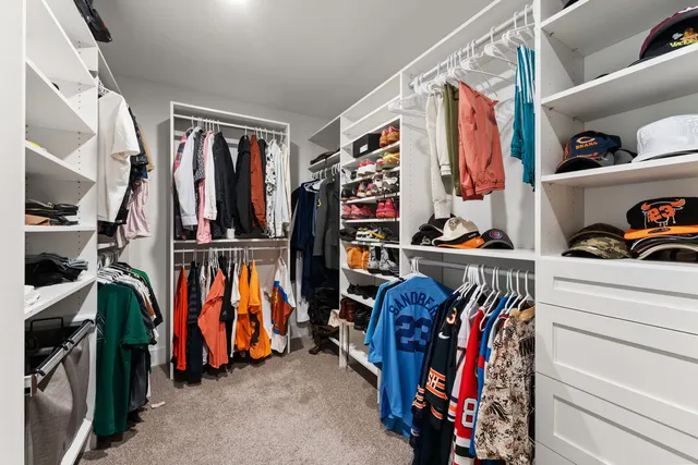 a view of walk in closet with clothes