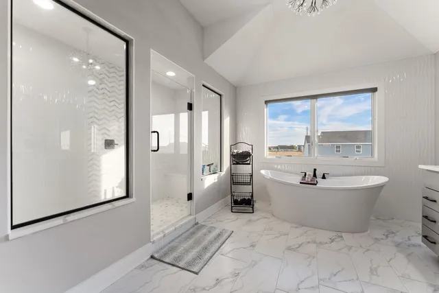 a bathroom with a bathtub and shower