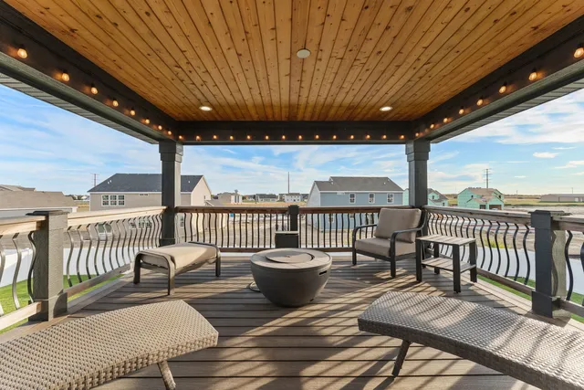 a view of a roof deck with a table and chairs
