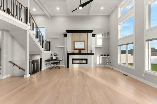a view of a livingroom with furniture staircase and windows