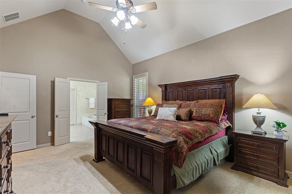 1217 Windmere Way Allen, TX 75013 - Photo 22 of 38 Vaulted ceilings and rich finishes create a peaceful primary retreat, where spacious comfort and a spa-inspired bath offer the perfect escape at the end of the day.