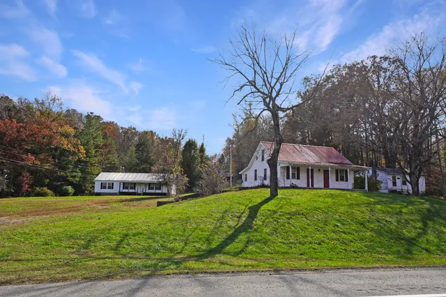 a view of a house with garden and trees
