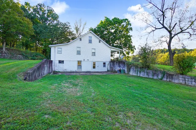a kitchen with white cabinets and sink