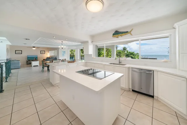 a kitchen with stainless steel appliances a stove a sink and a refrigerator