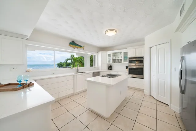 a kitchen with white cabinets and white appliances