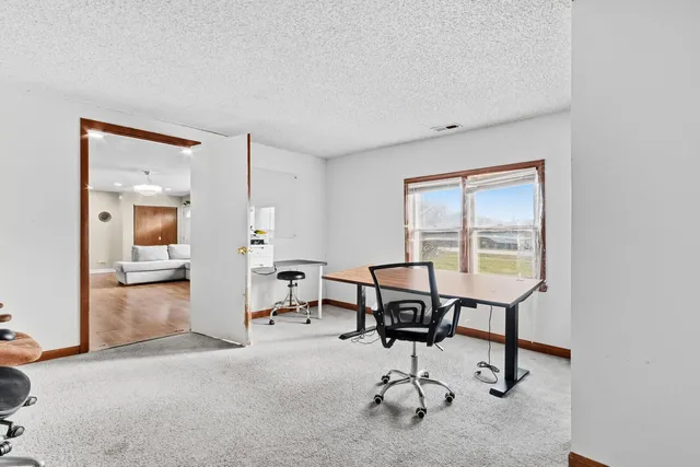 a room with a bed and a chair in it