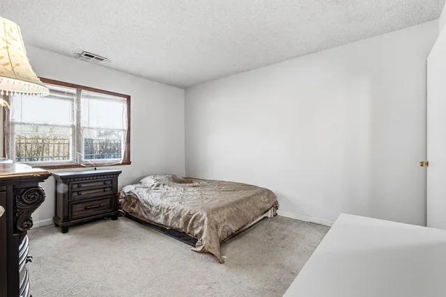 a bedroom with a bed and a table