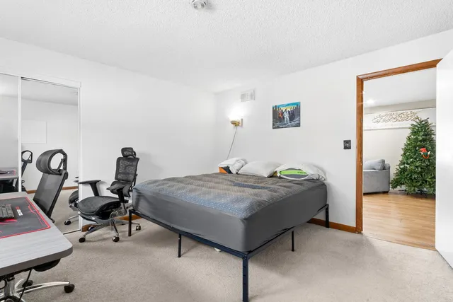 a bedroom with a bed next to a small yard