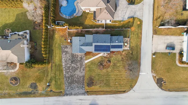 an aerial view of a house with a lake view