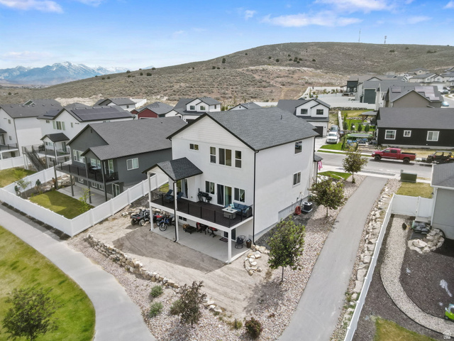 7889 Bristlecone Road Eagle Mountain, UT 84005 - Photo 37 of 42 Modern residence with two-story white exterior, dark trim, and a covered upper-level deck