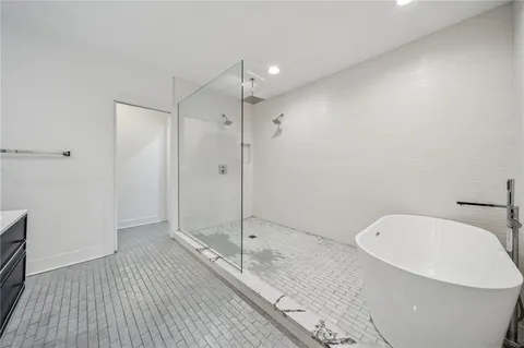 a bathroom with a bathtub and a shower