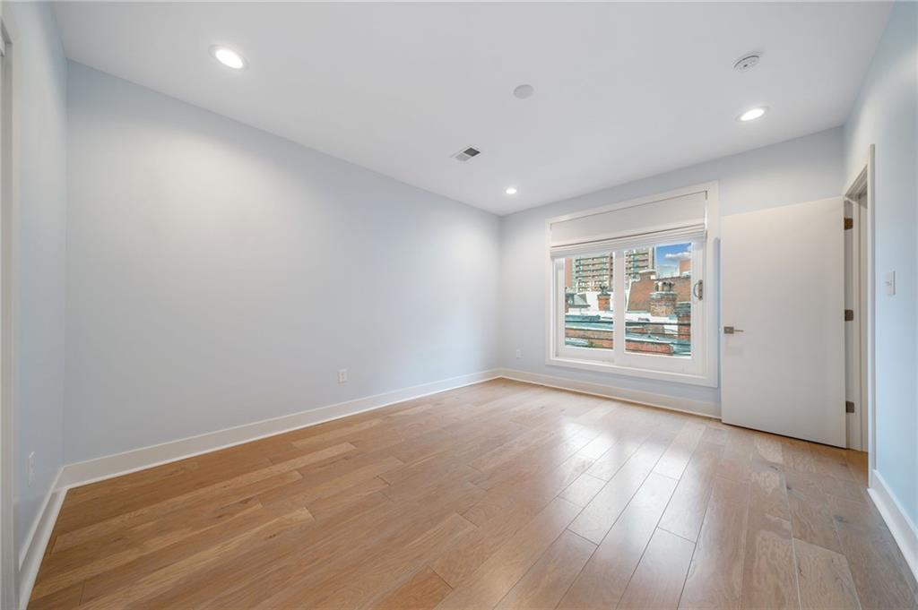 469 42nd Street Pittsburgh, PA 15201 - Photo 16 of 34 a view of an empty room with wooden floor and a window