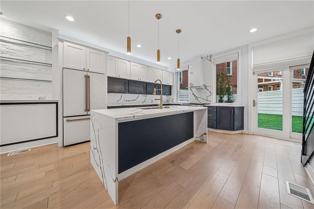 469 42nd Street Pittsburgh, PA 15201 - Photo 23 of 34 a kitchen with stainless steel appliances granite countertop a stove a sink and a refrigerator