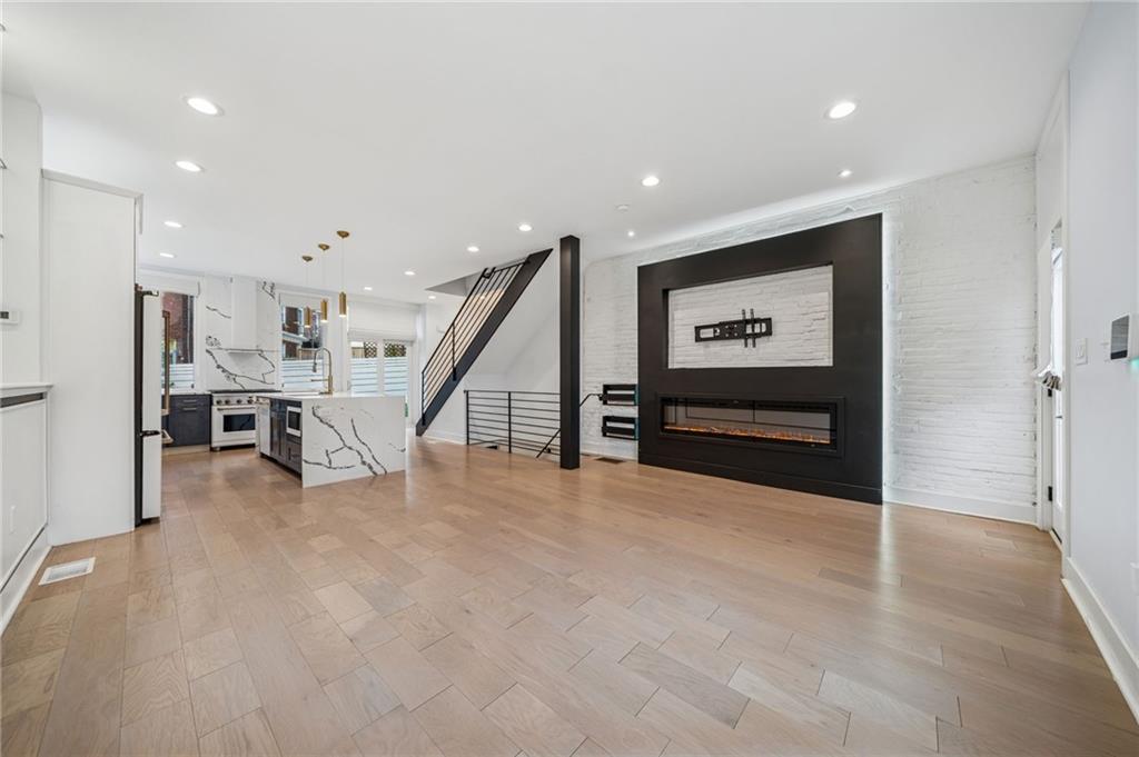 469 42nd Street Pittsburgh, PA 15201 - Photo 3 of 34 a view of an empty room with wooden floor and stairs