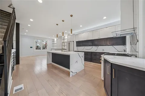 a kitchen with a sink stainless steel appliances and cabinets