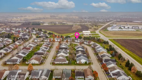 an aerial view of residential houses with city view