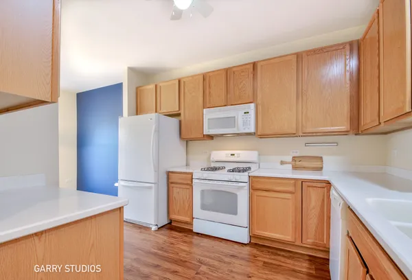 a kitchen with a sink a stove a refrigerator and cabinets