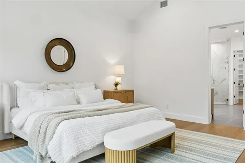 a bedroom with bed and a table
