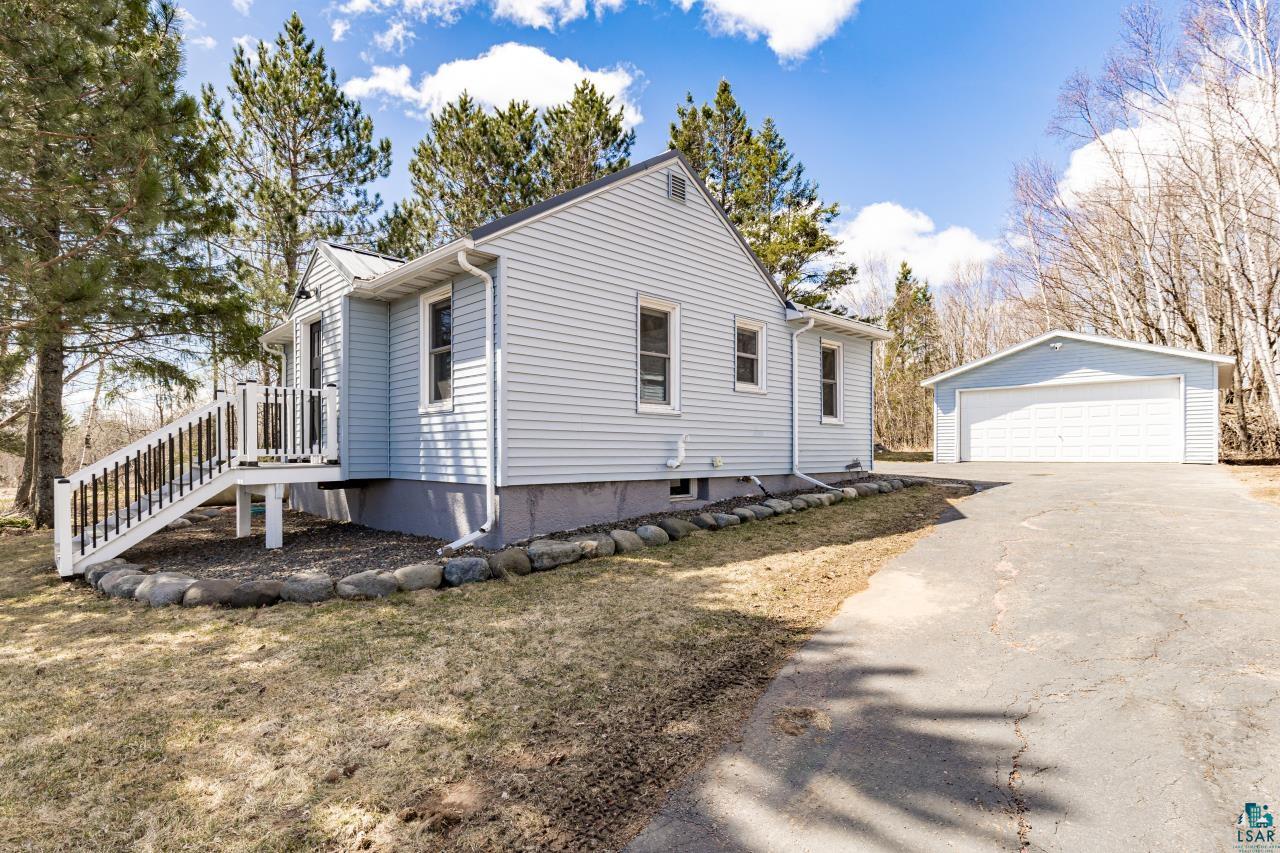 3645 Haines Road Hermantown, MN 55811 - Photo 13 of 35 Light blue siding exterior with white trim and a gabled roofline