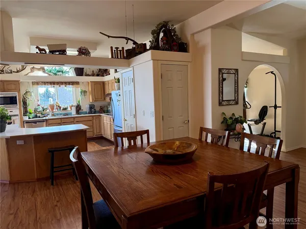 a dining room with furniture and wooden floor
